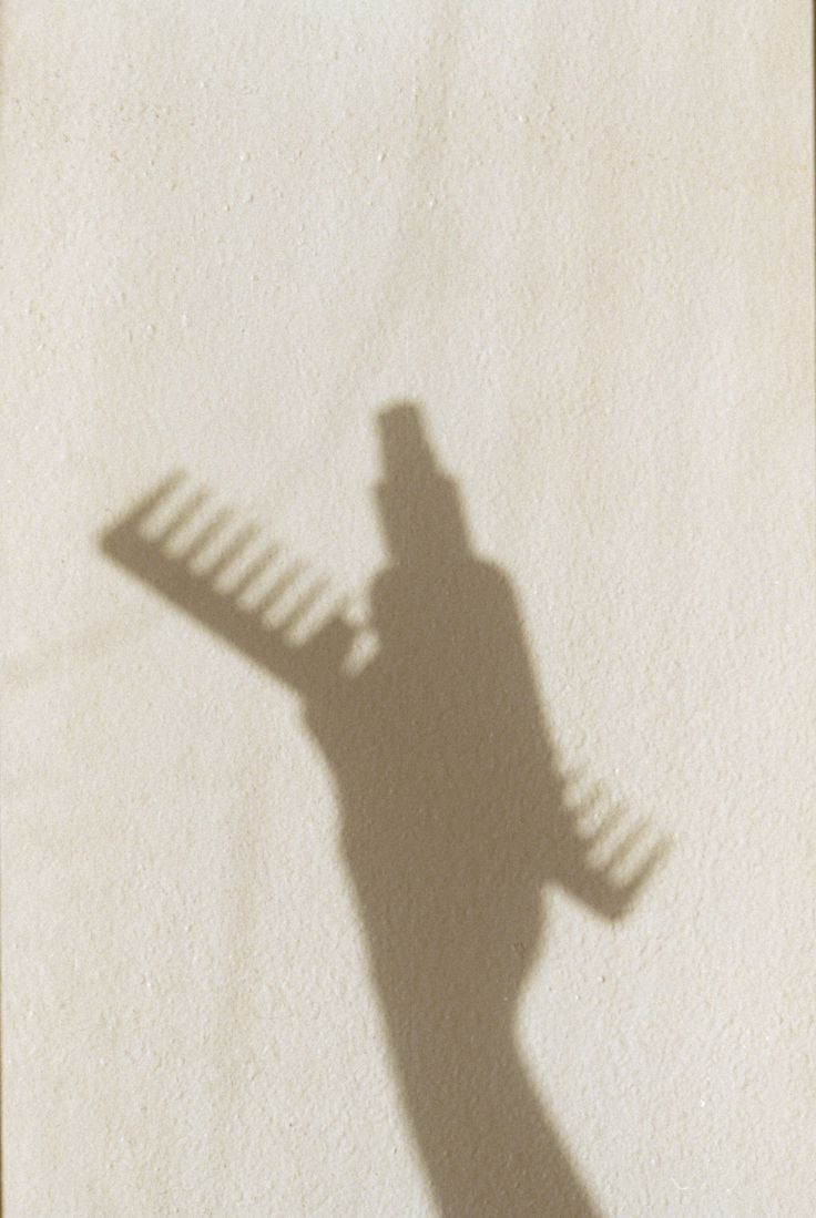 hair comb and spray shadow on neutral backdrop